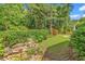 The home has a backyard with a swing and a rock garden at 128 Knotty Pine Way, Murrells Inlet, SC 29576