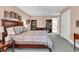 The bedroom features a stately wooden bedframe and matching dressers with shelving at 128 Knotty Pine Way, Murrells Inlet, SC 29576