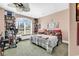 Cozy bedroom with large window, bookshelf, and fan at 128 Knotty Pine Way, Murrells Inlet, SC 29576