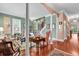 Inviting living room with wood floors, neutral walls, and staircase in this bright and airy home at 128 Knotty Pine Way, Murrells Inlet, SC 29576