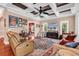 This living room has a wall of windows that bring lots of light and beautiful wood floors at 128 Knotty Pine Way, Murrells Inlet, SC 29576