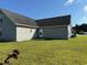Well-maintained backyard featuring a grassy lawn and exterior access door for outdoor enjoyment at 140 Blue Pride Dr., Loris, SC 29569