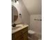 Cozy bathroom featuring a sink, toilet, vanity and round mirror with decorative accents at 140 Blue Pride Dr., Loris, SC 29569