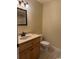 Bathroom featuring a vanity sink, toilet, and mirror with natural light at 140 Blue Pride Dr., Loris, SC 29569