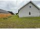 View of home's exterior, showing windows and landscaped backyard area at 140 Blue Pride Dr., Loris, SC 29569