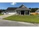 Charming single-story home with a well-manicured lawn and a two-car garage at 140 Blue Pride Dr., Loris, SC 29569