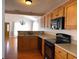 Well-equipped kitchen with wooden cabinets and modern black appliances at 140 Blue Pride Dr., Loris, SC 29569