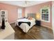 Comfortable bedroom with a large bed, two windows, and coastal-themed decor at 147 Weatherboard Ct., Pawleys Island, SC 29585