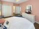 Well-lit bedroom featuring a comfortable bed, dresser, and closet at 147 Weatherboard Ct., Pawleys Island, SC 29585
