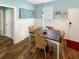 Cozy dining area with wainscoting, wood-look floors, and a rustic wooden table and chairs at 147 Weatherboard Ct., Pawleys Island, SC 29585