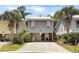 Charming coastal home featuring pink shutters, a metal roof, and a low maintenance gravel driveway at 147 Weatherboard Ct., Pawleys Island, SC 29585
