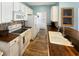 White kitchen features updated appliances and wood countertops providing a modern look and feel at 147 Weatherboard Ct., Pawleys Island, SC 29585
