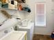 Bright laundry room with storage shelving, a washing machine, and a dryer at 147 Weatherboard Ct., Pawleys Island, SC 29585