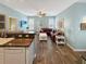 Bright, open living area with a sectional sofa, wood-look flooring, and access to the kitchen at 147 Weatherboard Ct., Pawleys Island, SC 29585