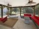 Relaxing screened-in porch with comfortable seating, hammock, and ceiling fans at 147 Weatherboard Ct., Pawleys Island, SC 29585