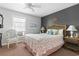 Bedroom with a wicker bed frame, ceiling fan, area rug, and large window at 1710-C Edge Dr., North Myrtle Beach, SC 29582