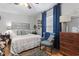 Bedroom with area rug, ceiling fan, wooden floors, and large window with curtains at 1710-C Edge Dr., North Myrtle Beach, SC 29582