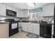 Well-lit kitchen features sleek countertops, white cabinetry, and modern black appliances at 1710-C Edge Dr., North Myrtle Beach, SC 29582