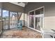 Relaxing screened porch features stylish outdoor seating and a ceiling fan for comfortable outdoor living at 1710-C Edge Dr., North Myrtle Beach, SC 29582