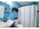 Cozy bathroom features a vanity with a round mirror, toilet, and shower with a curtain at 174 Edward Ave., Murrells Inlet, SC 29576