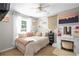 Sunlit bedroom with white furniture, macrame wall decor, and stylish vanity area at 174 Edward Ave., Murrells Inlet, SC 29576