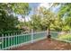 Relaxing wood deck view with a charming white picket fence and outdoor fireplace overlooking the river at 174 Edward Ave., Murrells Inlet, SC 29576