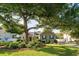 Charming home with mature trees, lush landscaping, and a well-manicured lawn at 174 Edward Ave., Murrells Inlet, SC 29576