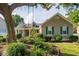 Inviting home featuring beautiful landscaping, a cozy porch, and blue window shutters at 174 Edward Ave., Murrells Inlet, SC 29576