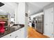 Open-concept kitchen featuring stainless steel appliances, granite countertops, and hardwood floors at 174 Edward Ave., Murrells Inlet, SC 29576