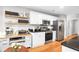 Well-lit kitchen featuring stainless steel appliances, granite countertops, and floating wooden shelves at 174 Edward Ave., Murrells Inlet, SC 29576