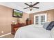 Bright and spacious main bedroom featuring a ceiling fan, a window, and an attached private bath at 174 Edward Ave., Murrells Inlet, SC 29576