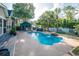 Beautiful backyard pool area surrounded by lush landscaping, a gazebo, and a white fence at 174 Edward Ave., Murrells Inlet, SC 29576