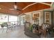 Covered porch boasts a wood ceiling, wicker furniture, and views of the backyard at 174 Edward Ave., Murrells Inlet, SC 29576