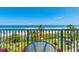 Balcony view showcasing the ocean, beach, lush green grass, chairs, and table at 201 74Th Ave. N # 2333, Myrtle Beach, SC 29572