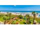 Beach view with colorful umbrellas, palm trees, grassy area, and wooden walkway at 201 74Th Ave. N # 2333, Myrtle Beach, SC 29572