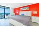 Inviting bedroom with balcony, red accent wall, stylish furnishings and ocean-themed artwork at 201 74Th Ave. N # 2333, Myrtle Beach, SC 29572