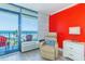 Cozy bedroom featuring recliner, side table with lamp, TV, and ocean view at 201 74Th Ave. N # 2333, Myrtle Beach, SC 29572