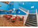 Bright dining area with stairs to the indoor pool, art and wood-look floors at 201 74Th Ave. N # 2333, Myrtle Beach, SC 29572
