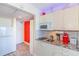Compact kitchenette with microwave, cooktop, sink, and granite counters for preparing meals at 201 74Th Ave. N # 2333, Myrtle Beach, SC 29572