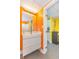Bright bathroom with white vanity, silver faucet, mirror, and orange walls at 201 74Th Ave. N # 2740, Myrtle Beach, SC 29572