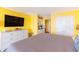Bedroom featuring TV, chest of drawers, kitchenette and exterior entry door at 201 74Th Ave. N # 2740, Myrtle Beach, SC 29572