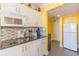 Efficient kitchen with white cabinets, granite countertops, and stainless microwave at 201 74Th Ave. N # 2740, Myrtle Beach, SC 29572