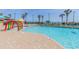 Resort swimming pool with beach views, colorful play structures, lounge chairs, and lush palm trees at 201 74Th Ave. N # 2740, Myrtle Beach, SC 29572