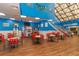 Large open restaurant area with games, high ceilings, and beach-themed decor at 201 74Th Ave. N # 2740, Myrtle Beach, SC 29572