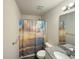 Cozy bathroom featuring a shower with decorative curtain and a granite countertop sink at 2021 Loblolly St., Georgetown, SC 29440