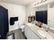 Well-lit bathroom featuring double sinks, granite countertop, and modern fixtures providing a touch of luxury at 2021 Loblolly St., Georgetown, SC 29440