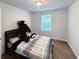 Bedroom with teddy bear, a window for light, and a modern platform bed at 2021 Loblolly St., Georgetown, SC 29440