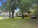 Well-maintained front yard with mature trees and a glimpse of the home's facade at 2021 Loblolly St., Georgetown, SC 29440