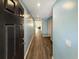 Long hallway with blue accent walls and wood look floors with several doors leading to other rooms at 2021 Loblolly St., Georgetown, SC 29440