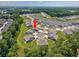 Aerial view showcases a house in a residential community with a lake and green spaces at 204 Kinross Ct., Little River, SC 29566